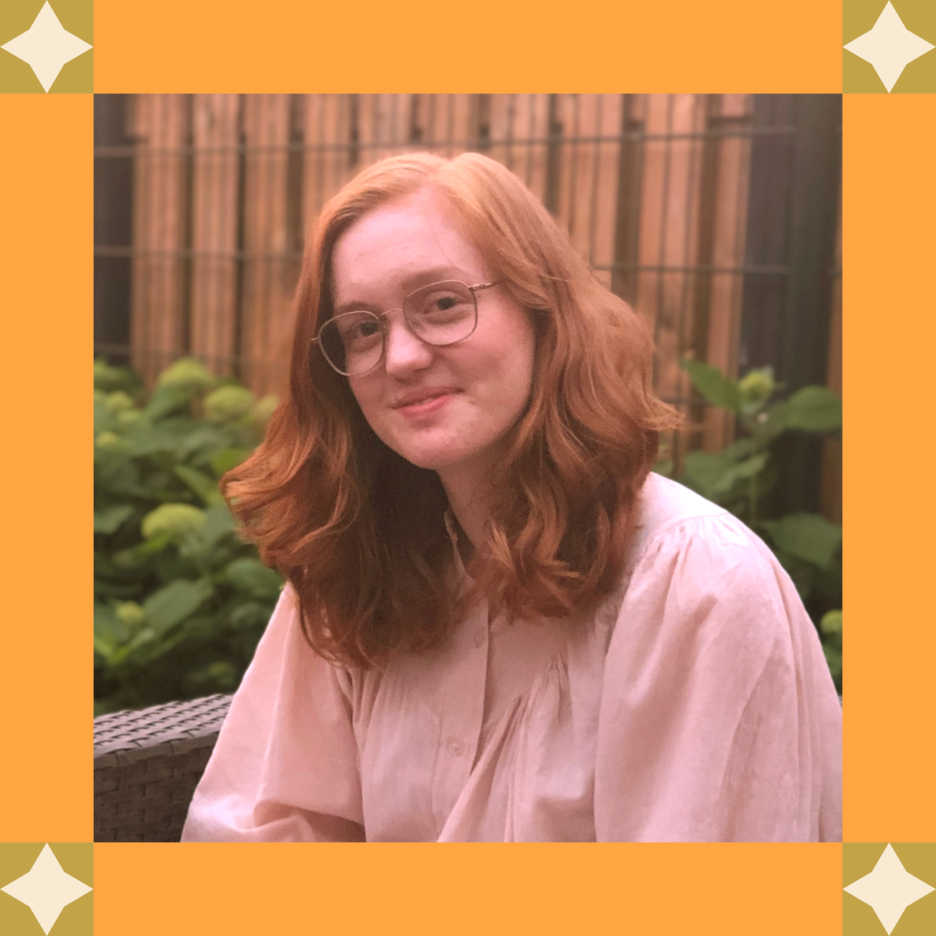 Ilse sitting outside with a sketchbook and pencil, in an orange frame